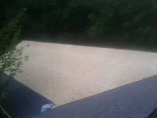 New OSB roof sheathing installed beside an existing shingle roof in Ringwood