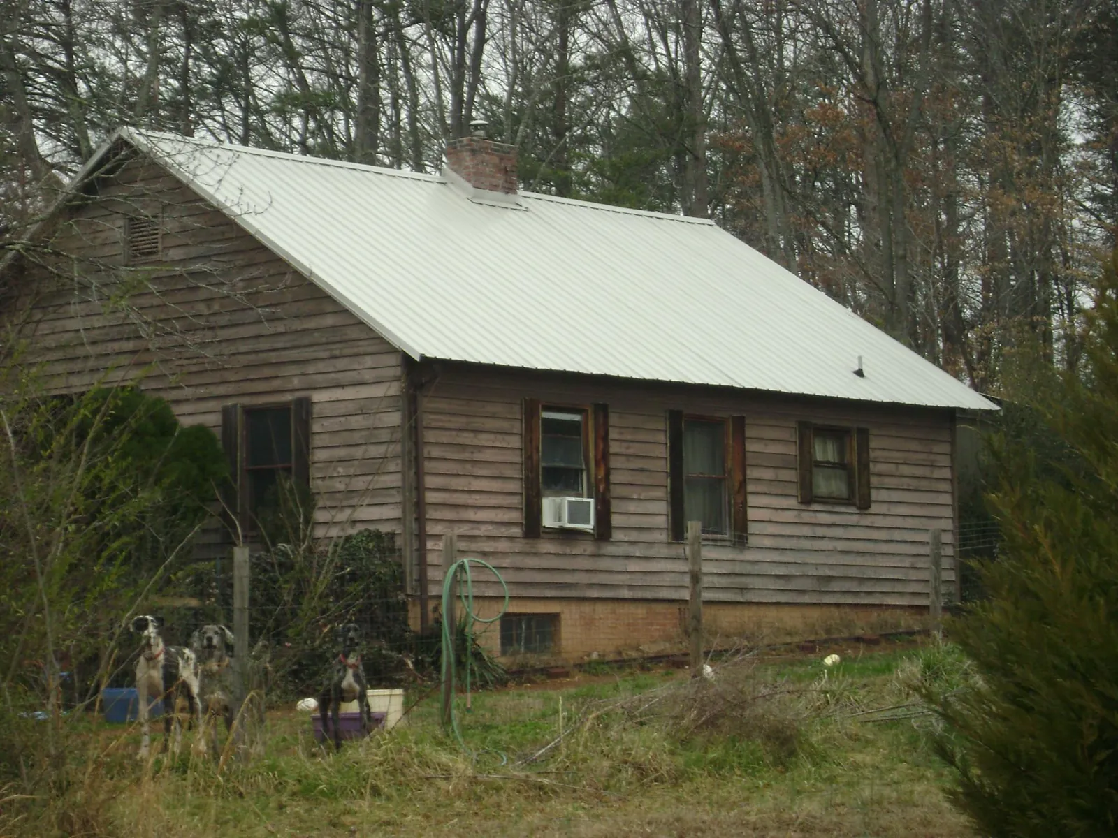 White metal roof on an old wood sided farmhouse, from a Metal Roof Installation job in Ringwood
